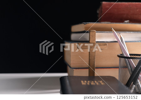 Old library, an open Bible lay on the table, its holy pages of scripture illuminated in the dark room. bible, holy, dark, old, open, library, pages, scripture, table, book, page. Old library, an open Bible lay on the table, its holy pages of scripture illuminated in the dark room. bible, holy, dark, old, open, library, pages, scripture, table, book, page. 125653152