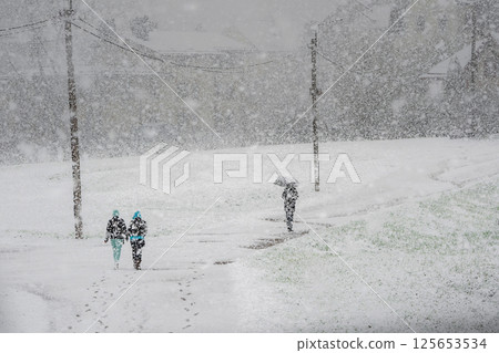 silhouette of a peoples in a heavy snowstorm silhouette of a peoples in a heavy snowstorm 125653534