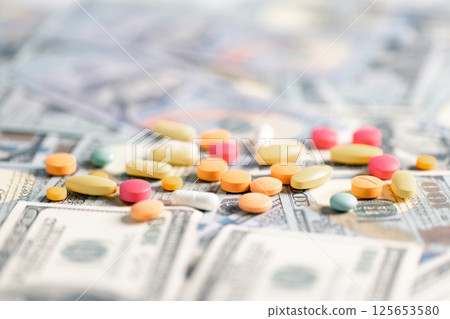 Medical business, a doctor carefully manages the money for each dose of medication, ensuring that even narcotic prescriptions are given against a backdrop of responsible health care. medicine, money. Medical business, a doctor carefully manages the money for each dose of medication, ensuring that even narcotic prescriptions are given against a backdrop of responsible health care. medicine, money. 125653580