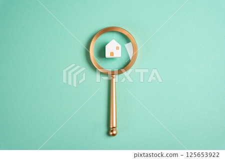 House and magnifying glass. Housing search concept. Real estate market analysis, property inspections, and comparing listings. Locate ideal housing opportunities for buyers and renters 125653922