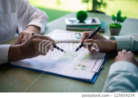 Business meeting on sustainable real estate development. real estate, sustainable development, business meeting, green building, eco-friendly, architecture, planning, construction, investment. 125654234