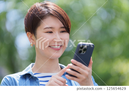 A woman using a smartphone A woman using a smartphone 125654629