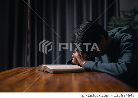 Person raised their hand in prayer at the church, embodying their Christian faith and belief in God, seeking hope and the holy presence of Christ through their devout religion. jesus christ, pray. Person raised their hand in prayer at the church, embodying their Christian faith and belief in God, seeking hope and the holy presence of Christ through their devout religion. jesus christ, pray. 125654642
