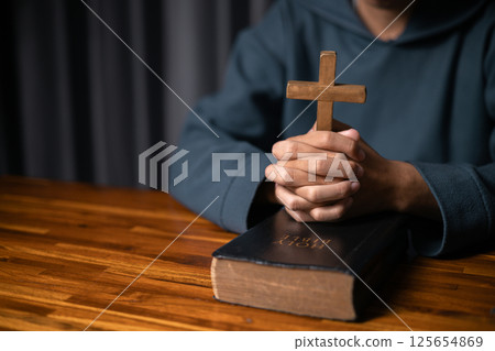 Person raised their hand in prayer at the church, embodying their Christian faith and belief in God, seeking hope and the holy presence of Christ through their devout religion. jesus christ, pray. Person raised their hand in prayer at the church, embodying their Christian faith and belief in God, seeking hope and the holy presence of Christ through their devout religion. jesus christ, pray. 125654869