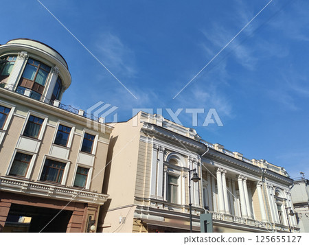 large multi-story building with a classic facade featuring arched windows and modern retail spaces on the ground floor. The blend of traditional architecture and urban commercial life reflects the large multi-story building with a classic facade featuring arched windows and modern retail spaces on the ground floor. The blend of traditional architecture and urban commercial life reflects the 125655127