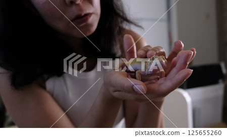 A leopard gecko crawls on a person s arm, displaying its vibrant scales. Such pets represent the growing trend of exotic animal care and responsibility. A leopard gecko crawls on a person s arm, displaying its vibrant scales. Such pets represent the growing trend of exotic animal care and responsibility. 125655260