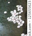 Cherry blossom petals floating on the water surface 125655623