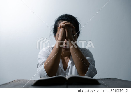 Christian life crisis prayer to god. Woman Pray for god blessing to wishing have a better life. woman hands praying to god with the bible. begging for forgiveness and believe in goodness. 125655642
