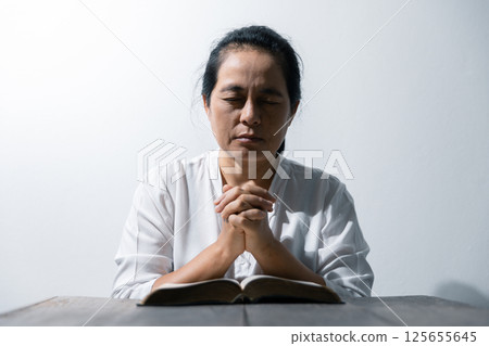 Christian life crisis prayer to god. Woman Pray for god blessing to wishing have a better life. woman hands praying to god with the bible. begging for forgiveness and believe in goodness. Christian life crisis prayer to god. Woman Pray for god blessing to wishing have a better life. woman hands praying to god with the bible. begging for forgiveness and believe in goodness. 125655645
