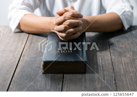 Christian life crisis prayer to god. Woman Pray for god blessing to wishing have a better life. woman hands praying to god with the bible. begging for forgiveness and believe in goodness. Christian life crisis prayer to god. Woman Pray for god blessing to wishing have a better life. woman hands praying to god with the bible. begging for forgiveness and believe in goodness. 125655647