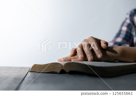 Christian life crisis prayer to god. Woman Pray for god blessing to wishing have a better life. woman hands praying to god with the bible. begging for forgiveness and believe in goodness. 125655661