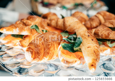 Fresh Baked Croissants Filled with Salmon and Greens 125655666
