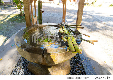 Traditional Japanese ritual washing hands sink station with bamboo ladle 125655716