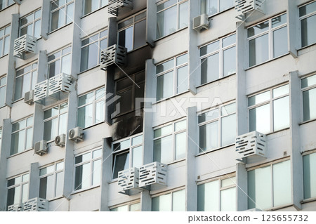 Consequences of a fire in a multi-storey building. Damaged multi-storey building, the aftermath of the explosion 125655732