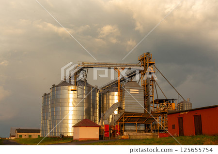 A captivating sunset over a grain dryer and hopper A captivating sunset over a grain dryer and hopper 125655754