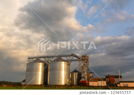 A captivating sunset over a grain dryer and hopper A captivating sunset over a grain dryer and hopper 125655757