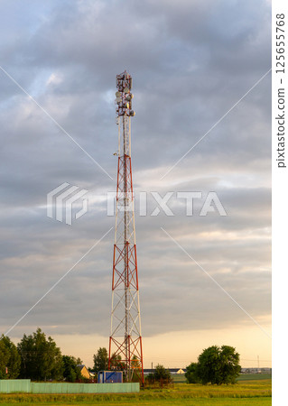 Sunset over rural farmland with cell tower Sunset over rural farmland with cell tower 125655768