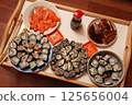 table with a set of rolls and sauce 125656004