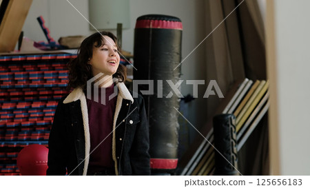 A young girl in casual wear strikes a confident pose, speaking or reacting with enthusiasm. The scene emphasizes youth, creativity, and self-expression in a dynamic indoor setting. A young girl in casual wear strikes a confident pose, speaking or reacting with enthusiasm. The scene emphasizes youth, creativity, and self-expression in a dynamic indoor setting. 125656183