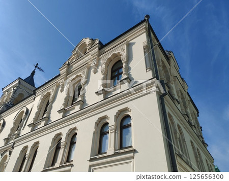 A close-up view of a neoclassical building with intricate detailing, showcasing the richness of traditional architecture and its harmony with the environment. A close-up view of a neoclassical building with intricate detailing, showcasing the richness of traditional architecture and its harmony with the environment. 125656300