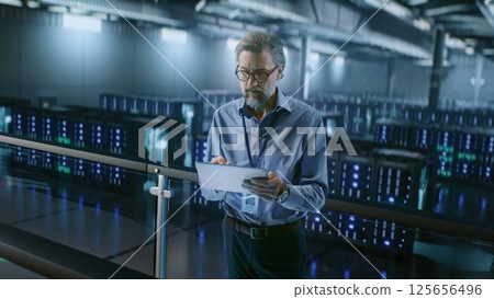 Big Data Center with Server Racks: Professional Specialist Using Tablet Computer, Activating Servers Big Data Center with Server Racks: Professional Specialist Using Tablet Computer, Activating Servers 125656496