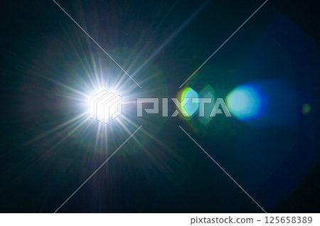 Sun flare on the black background 125658389