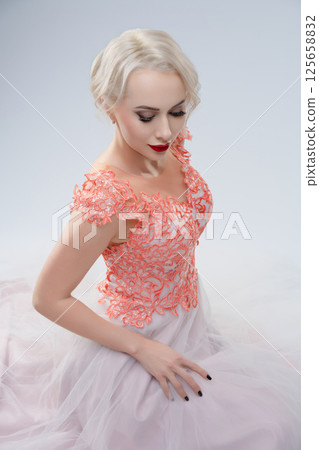 Bridal portrait with a dramatic touch of blood in a studio setting 125658832