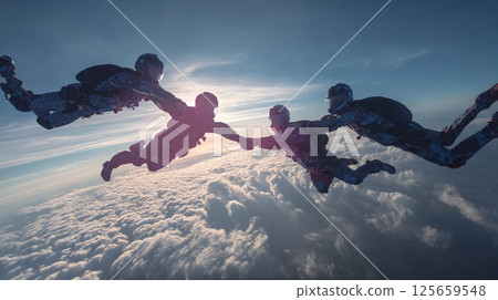 Skydiving team flying in the blue sky 125659548