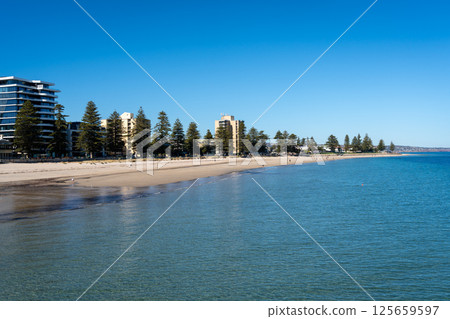 Golden sand and blue waters at Glenelg Beach, Adelaide, Australia 125659597