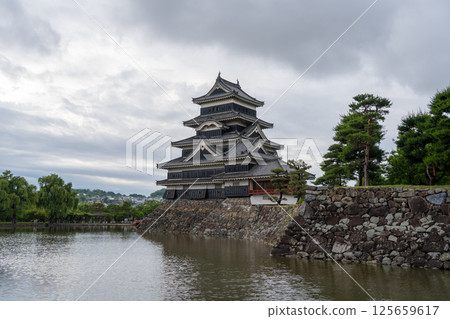 Historic Matsumoto Castle reflected in calm waters, Japan 125659617