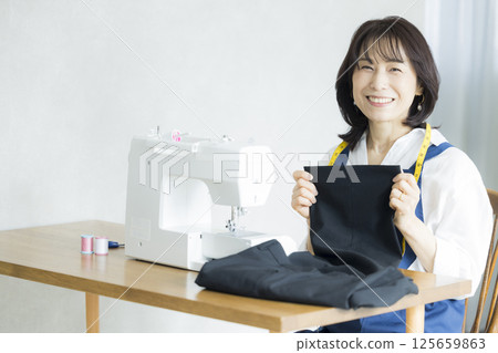 Woman doing dressmaking at home 125659863
