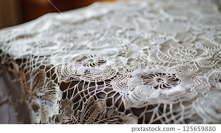 A lace tablecloth with intricate patterns, adding elegance to any dining experience, perfect for any occasion. 125659880