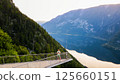 Young man standing on the viewing platform with drone controller view of Hallstatt lake, mountains 125660151