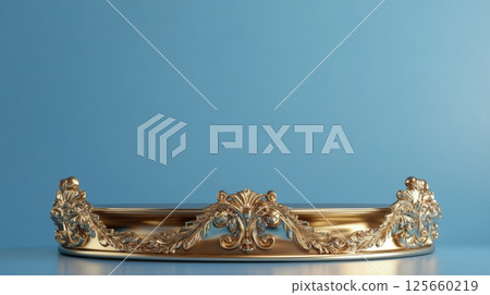 Golden ornate tray against blue background, luxury decorative concept 125660219