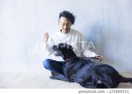 Man relaxing with his dog 125660515