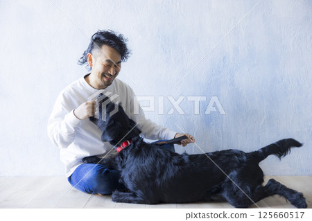 Man relaxing with his dog 125660517
