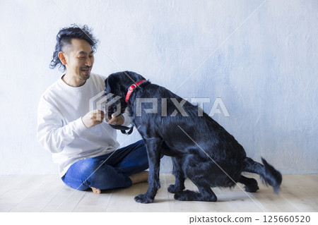 Man relaxing with his dog Man relaxing with his dog 125660520