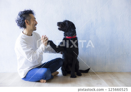 Man relaxing with his dog 125660525