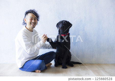 Man relaxing with his dog 125660528