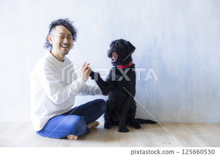 Man relaxing with his dog 125660530