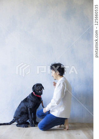 Man relaxing with his dog 125660535