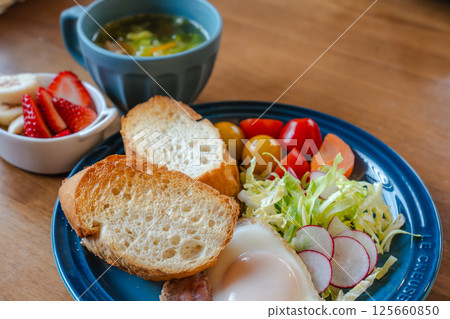 Colorful breakfast plate with fried eggs and bread 125660850