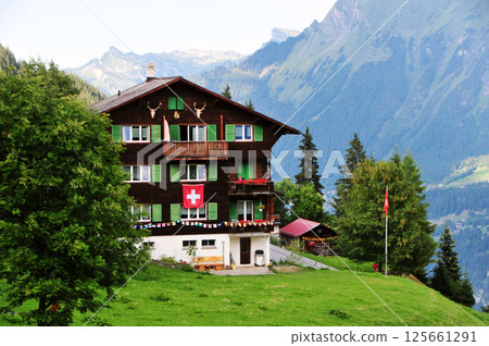 Traditional wooden houses in the valleys of the Swiss Alps 125661291