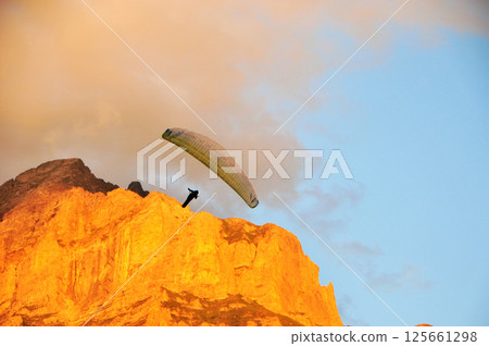 paragliding in the mountains 125661298