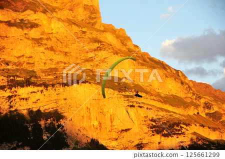 paragliding in the mountains 125661299
