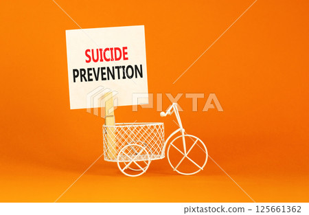 Suicide prevention symbol. Concept words Suicide prevention on beautiful white paper on clothespin. Beautiful orange table orange background. Psychological and suicide prevention concept. Copy space. 125661362