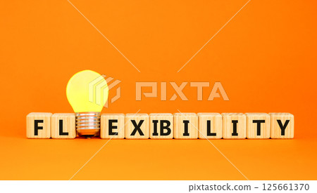 Flexibility symbol. Concept word Flexibility on beautiful wooden blocks. Beautiful orange table orange background. Yellow light bulb. Business flexibility concept. Copy space. Flexibility symbol. Concept word Flexibility on beautiful wooden blocks. Beautiful orange table orange background. Yellow light bulb. Business flexibility concept. Copy space. 125661370