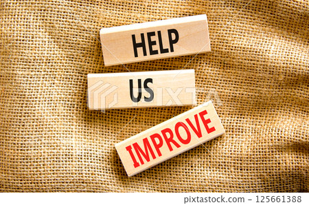 Help us improve symbol. Concept words Help us improve on beautiful wooden blocks. Beautiful canvas table canvas background. Business motivational help us improve concept. Copy space. 125661388