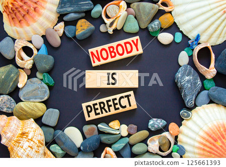Nobody is perfect symbol. Concept words Nobody is perfect on beautiful block. Sea stones shells. Beautiful black background. Business motivational lifestyle and nobody is perfect concept. Copy space. Nobody is perfect symbol. Concept words Nobody is perfect on beautiful block. Sea stones shells. Beautiful black background. Business motivational lifestyle and nobody is perfect concept. Copy space. 125661393