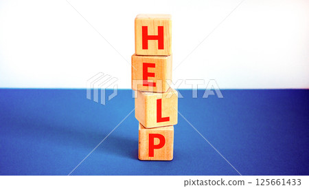 Help symbol. Concept word Help on beautiful wooden blocks. Beautiful white and blue background. Business, lifestyle, support and help concept. Copy space. 125661433